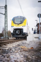 Modern locomotive at close range on railway tracks under grey skies, opening of the Hermann Hesse