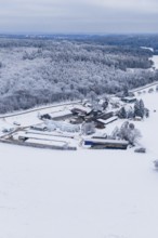 Snowy landscape with farm surrounded by forests and fields under grey skies, Haselstaller Hof,