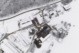 Farm from above in a snowy winter landscape with snow-covered roofs, Haselstaller Hof, Gechingen,