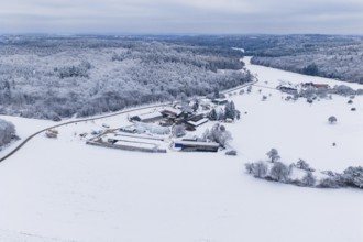 Extensive winter landscape with a snowy farm surrounded by forests and fields, Haselstaller Hof,