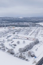 A snow-covered substation with power lines and surrounding trees in a winter landscape, substation,