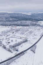 Aerial view of a snowy substation in a vast winter landscape, substation, Jettingen, Germany
