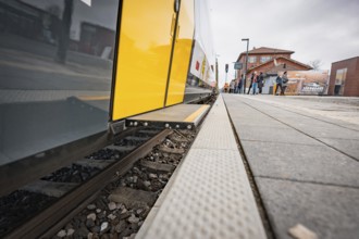 Close-up of a yellow train on the tracks of a train station, Siemens Micro Plus B battery electric