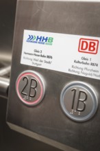 Close-up of track number plates and buttons in a train station, battery electric train Siemens