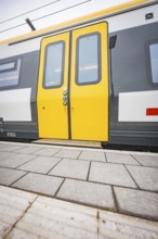 Close-up of a yellow train door on a platform, Siemens Micro Plus B battery electric train,