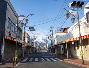 Road through the Japanese town of Fujiyoshida, behind the volcano Mt. Fuji, Yamanashi Prefecture,