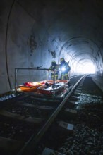 Firefighters stand on an ambulance in a tunnel, equipped for a mission, fire drill on the