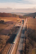 A train travels on rails parallel to a country road at a tunnel in a scenic area, fire drill on the
