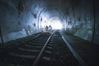 Two firefighters drive an ambulance in a dark tunnel, fire drill on the Hermann-Hesse railway,