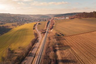 Aerial view of a rural area with fields, village and parallel traffic routes, fire drill on the