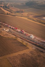 Fire service on a country road in a hilly area at sunset, fire drill on the Hermann Hesse Railway,