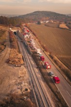 Aerial view of a scenario with emergency vehicles along a tunnel and a road, fire drill at the