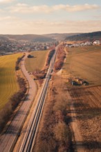 Aerial view of a rural area with railroad, road and village in the background, fire drill on the