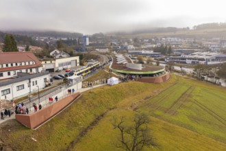 Station from above with surrounding urban landscape and people, drafty morning sky, opening of the