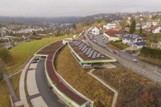 Hill with solar panels and roads in an urban residential area, opening of the Hermann Hesse