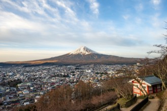 View of Mount Fuji volcano over Fujiyoshida City in morning light, at sunrise, Arakurayama Sengen