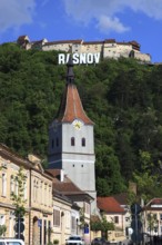 Town of Rasnov, German Rosenau. In the foreground is the distinctive clock tower of the Protestant