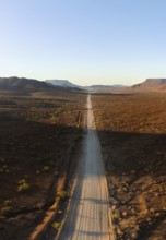 Aerial view, infinite space, straight road leads through dry desert landscape, hills in Damaraland,