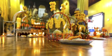 Sacrifices with candles, in front of numerous Buddhas and the City Pillar, which is considered the