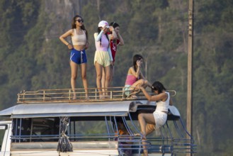 Photo shoot with young girls in the karst landscape near Vang Vieng, Vientiane province, Laos