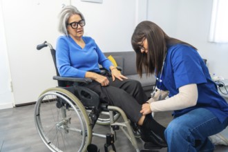 Care professional assisting an elderly woman in a wheelchair with her clothing, preparing for an