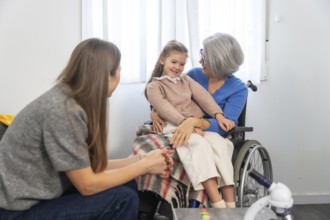 Family members connecting during a visit, with a smiling granddaughter sitting comfortably on her