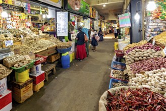 Bustling marketplace full of spices and vegetables with people in narrow corridors, The old market