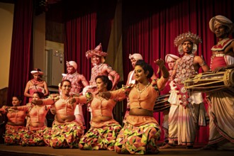 Dancers in colorful, traditional costumes dance with drummers on a stage, folklore and dancers from