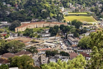 View of a historic fortress and a market square in an urban environment with lots of greenery, view