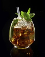 Cocktail in front of a black background, studio shot