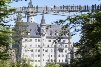 People on the Marienbrücke over the Pöllat Gorge, behind Neuschwanstein Castle near Hohenschwangau,