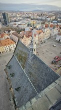 Bird's eye view of a town church with a distinctive tower and surrounding square, Pilsen, Czech