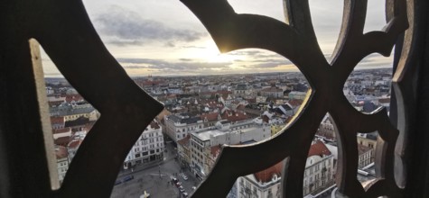 View through a decorated window of an urban landscape at sunset, Pilsen, Czech Republic