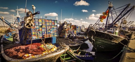Colourful fishing boats in the harbor with numerous nets and ropes under clear skies, vivid colors,