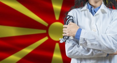 Healthcare professional with North Macedonia flag background. Professional doctor holding