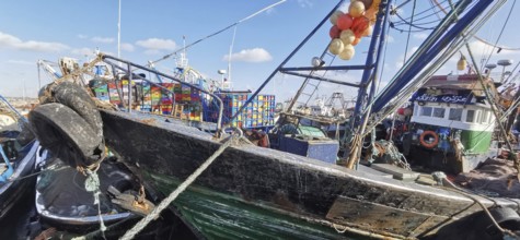 Close-up view of fishing boats with nets and colorful boxes in the harbor, Essaouira, Morocco