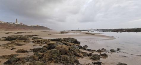 Rocky coast with calm sea under a cloudy sky, Morocco