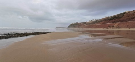 Extensive beach with calm sea and cloudy sky, Morocco