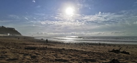 A quiet beach with bright sunshine and light surf, Morocco