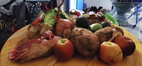 Various foods on wooden table, including fruit, vegetables and meat, Morocco