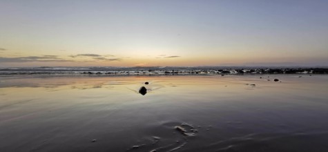 Evening on the beach with soft waves and peaceful horizon, Morocco
