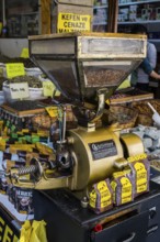 Antique coffee grinder next to spices and coffee on a busy market stall, Konya, Central Anatolia,