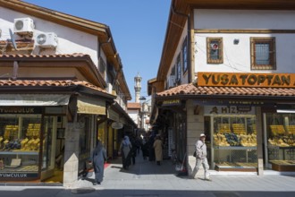 Lively market street with traditional shops and passers-by on a sunny day, jewelry shops, Konya,