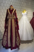 Two magnificent wedding dresses, one red with gold embroidery and one classic white dress,