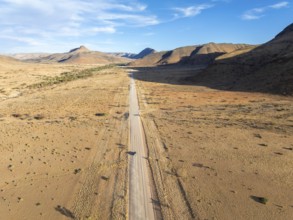 Aerial view, Eternally long straight road, road C14 through the Naukluft Mountains, desert and dry