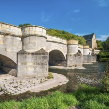 13th century medieval stone bridge across the Werra river, in the back the Liborius chapel,