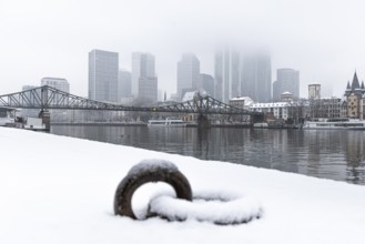 Clouds envelop Frankfurt's banking skyline. Heavy snowfalls have caused another onset of winter in
