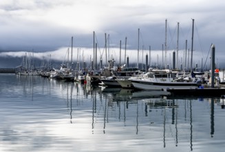 Boats in harbor, cloudy mountain peaks behind, with reflection, Seward, Kenai Peninsula, Alaska,