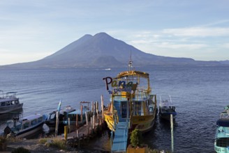 Boats on the dock, Lake Atitlán or Lake Atitlán in the morning, the volcanoes Atitlán and Toliman