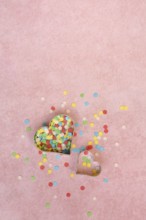 Two heart-shaped baking pans and sugar confetti